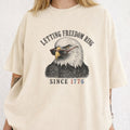 WZ_eagle_letting_freedom_ring_shopify_comfort_colors_1717_mockup_woman_2_ivory