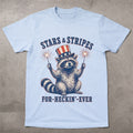 WZ_raccoon_stars_and_stripes_forever_shopify_comfort_colors_1717_flatlay_1_mockup_chambray