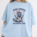 WZ_raccoon_stars_and_stripes_forever_shopify_comfort_colors_1717_mockup_woman_2_chambray