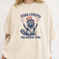 WZ_raccoon_stars_and_stripes_forever_shopify_comfort_colors_1717_mockup_woman_2_ivory